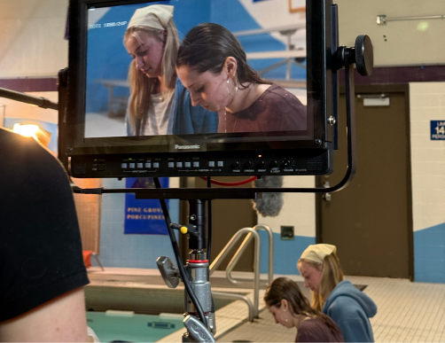 Facilities in Comm Arts - Students filming on location at a local school swimming pool