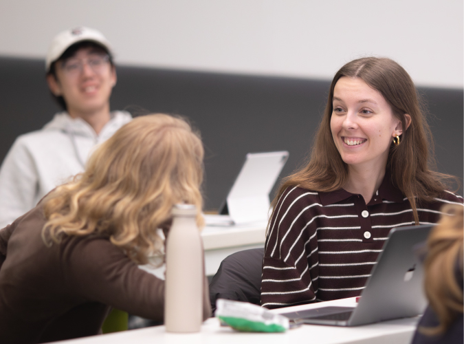 Undergrad students in Comm Arts 250 interacting in discussion.